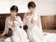 A couple of women sitting on top of a wooden floor.