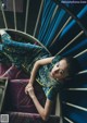 A woman laying on top of a spiral staircase.