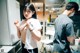 A man and a woman standing in a kitchen next to each other.