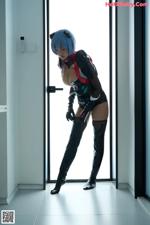 MiiTao Vol.148: 梦乃Mandy (74 photos) A woman in a black and red outfit standing in front of a door.